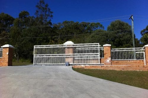 Cantilever Gates Deliver Huge white cantilever gate built on the drive-way